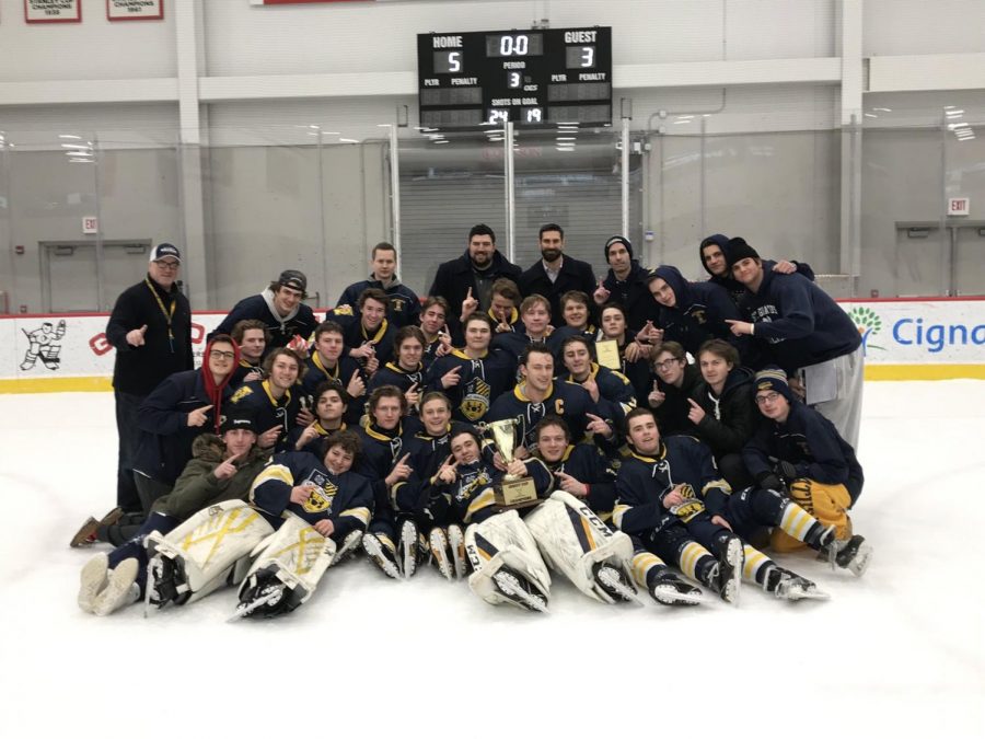 Wildcats+huddle+around+the+2019+Jesuit+Cup+trophy