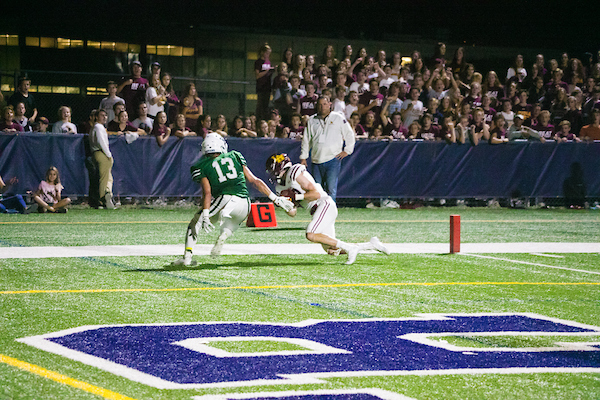 Rory Boos comes down with a touchdown catch in last year's victory over New Trier. 