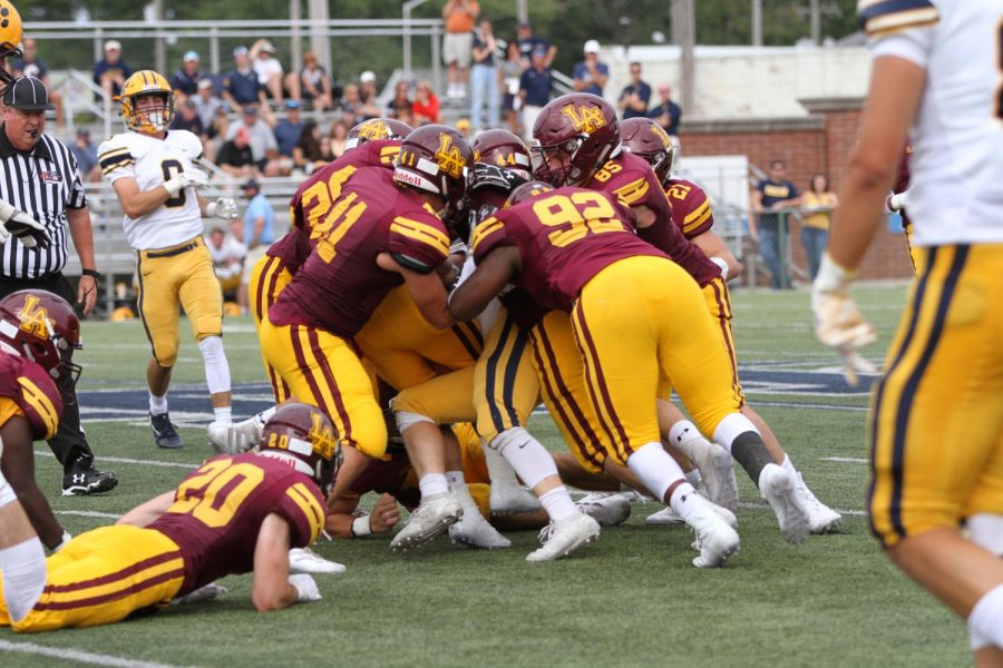 Rambler defense makes tackle against St Ignatius Cleveland. Ramblers suffered a defeat 27-10