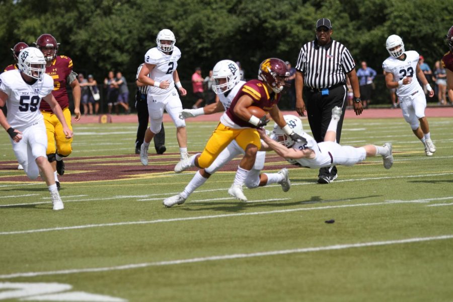 Junior Aidan Brownlee runs with the football in win over New Trier. 