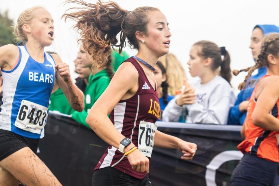 Junior Sarah Jay pushes ahead during the Palantine meet. Jay would go on to race at the State finals after a IHSA ruling. 