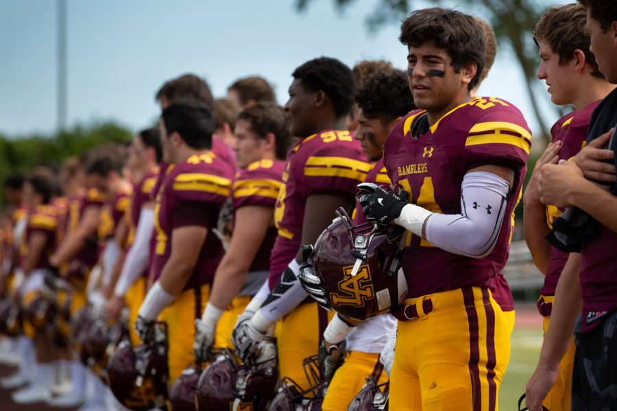 Senior Tyler Flores stands with the rest of his teammates during the national anthem at a football game this season.
Flores and his teammates will do their best to defeat rival Maine South in the first round of the playoffs. 