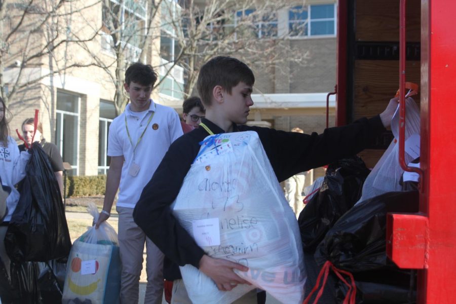 Loyola student places items to be donated to Blessed Virgin Mary families in the delivery truck. The Gonzaga Drive helped 317 families this year. 