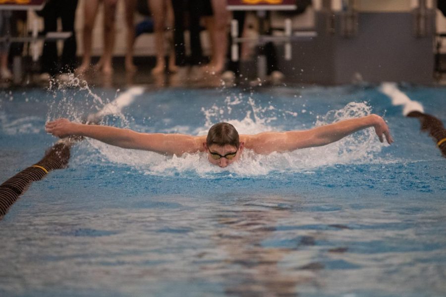 Senior captain Luke Maurer races to the finish in the butterfly at the senior night meet. He hopes to continue Loyolas winning streak at Evanston on Feb 29. 