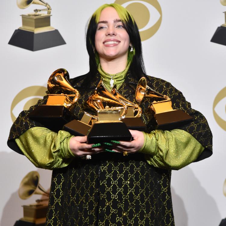 Billie Eillish shows off her five Grammy trophies. She was just one part of a night overshadowed by Kobe Bryants death. 
