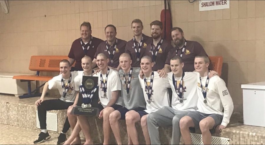 The boys swim team celebrates their big victory. 