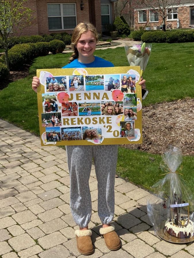 Jenna+Rekoske+poses+with+her+gifts+from+the+track+and+field+team.+The+team%0A+surprised+her+to+celebrate+Senior+Day.+