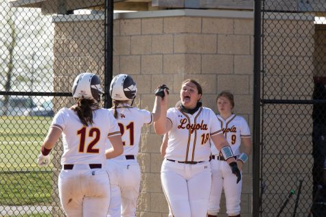 The softball team celebrate some runs at their game on the hill. The team is just one of seven at the hill who compete with the benefit of a locker room. 