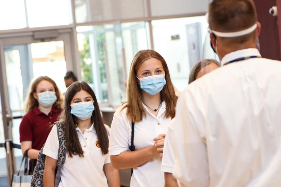 Students line up to have their temperature taken as part of the COVID rules at the start of the year. Students wonder what next year will hold, and hope for the best. 