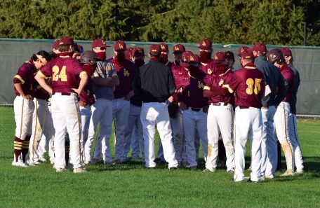 After a tough loss to GBN, the team huddles with head coach Ackels. The Ramblers were unable to get runners across the plate in the loss. 