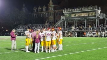 Players huddle up under the lights before their Friday Night game at
Barda-Dowling Stadium. The team would go on to win despite a late game push by the Caravan.