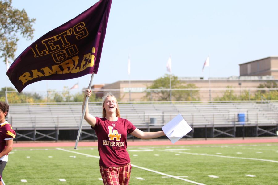 Ashley Voss waves the Rambler flag with pride during the Pep Rally. 