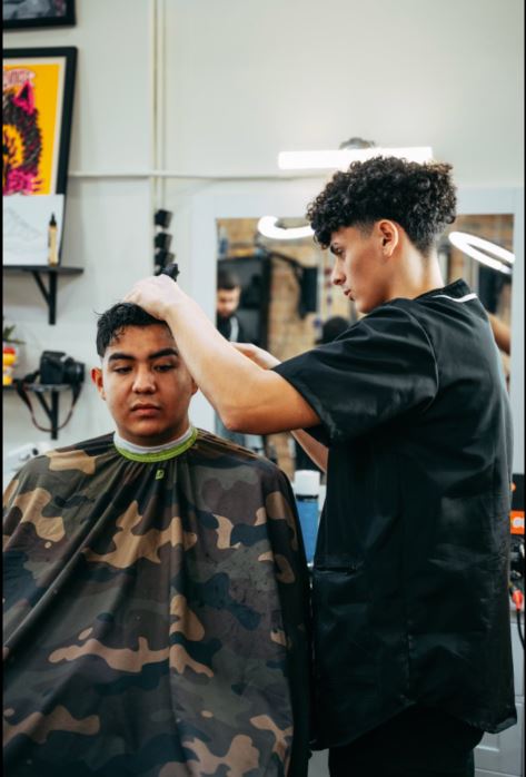 Max Garcia focuses on cutting a clients hair at Traditions Barber Parlor in Lincoln Park, Chicago.