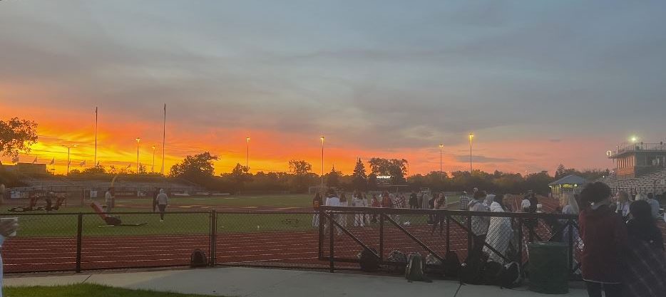 Senior students enjoy the views of the sunrise while eating provided breakfast of donuts, bagels, coffee, and hot chocolate on Wednesday morning. 