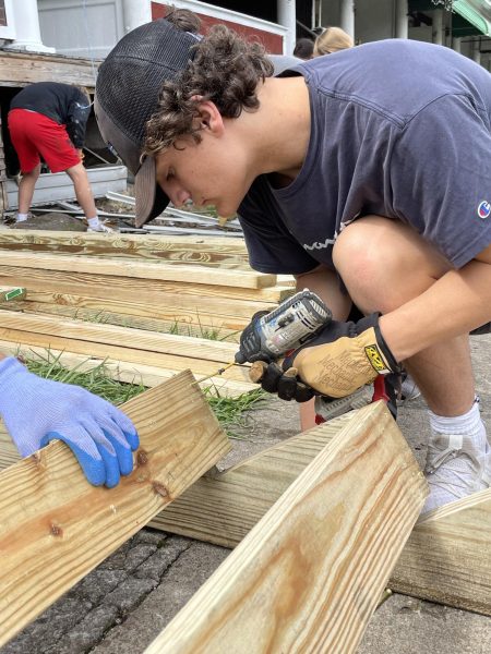 Senior James Roche works in West Virginia as part of his summer service trip. 