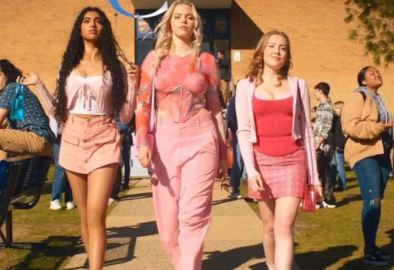 Regina (Reneé Rapp, who also played the role onBroadway) walking next to Gretchen (Bebe Wood) on the right and Karen (Avantika Vandanapu) on the left out of their North Shore high school in “Mean Girls.