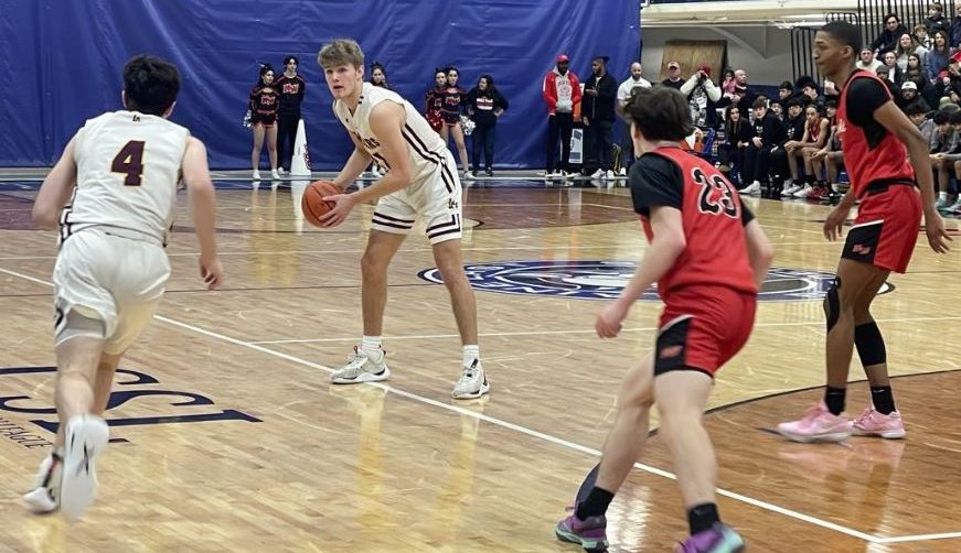Brendan Loftus looks to pass the ball to a teammate in the second quarter of the IHSA Regional Final game against Niles West on February 23, 2024. 