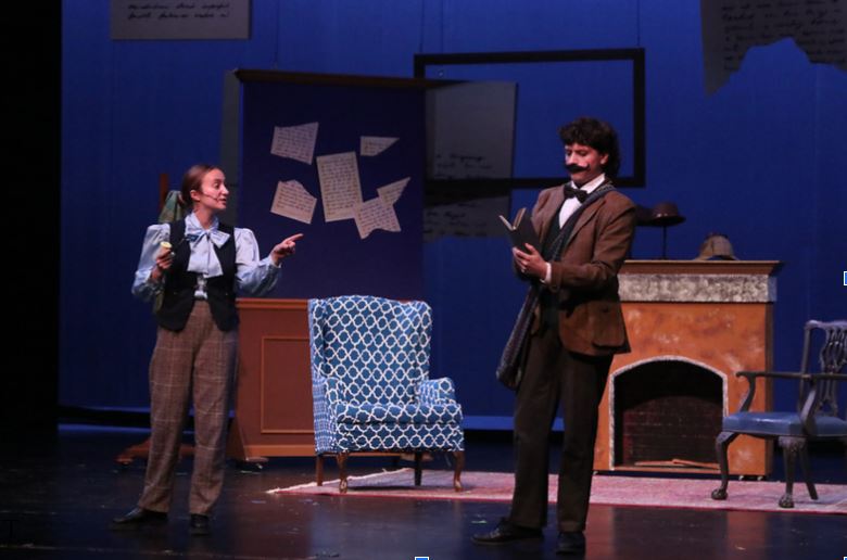 The play kicks off! Holmes and Watson begin solving their mystery for the night. These characters were played by Loyola seniors Lucy Kirkland and Colin San Roman, respectively. 