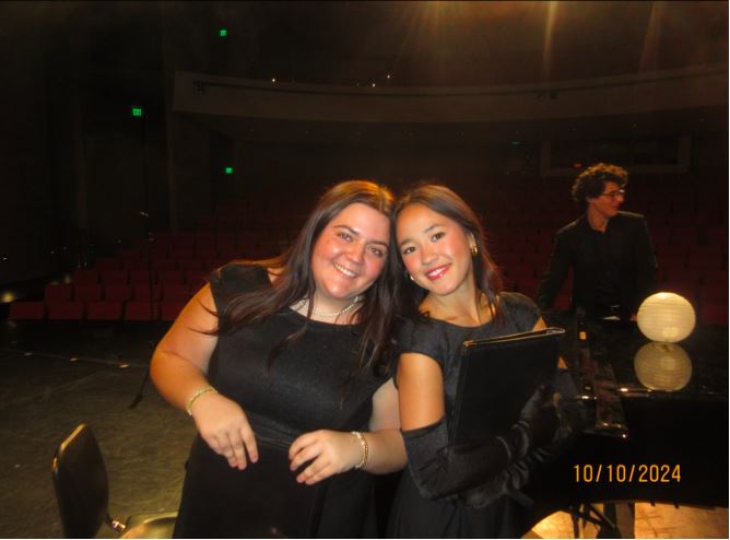 Sophia Daly and Lucy Rossman photographed using Madison Czuba’s digital camera at the Fall Choir Concert