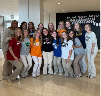 A group of seniors all sporting their college T-shirts on Decision Day. 